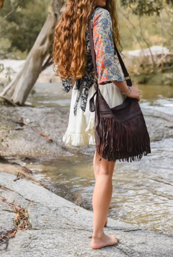 Handmade leather fringe shoulder bag in a vintage Western-Bohemian style.