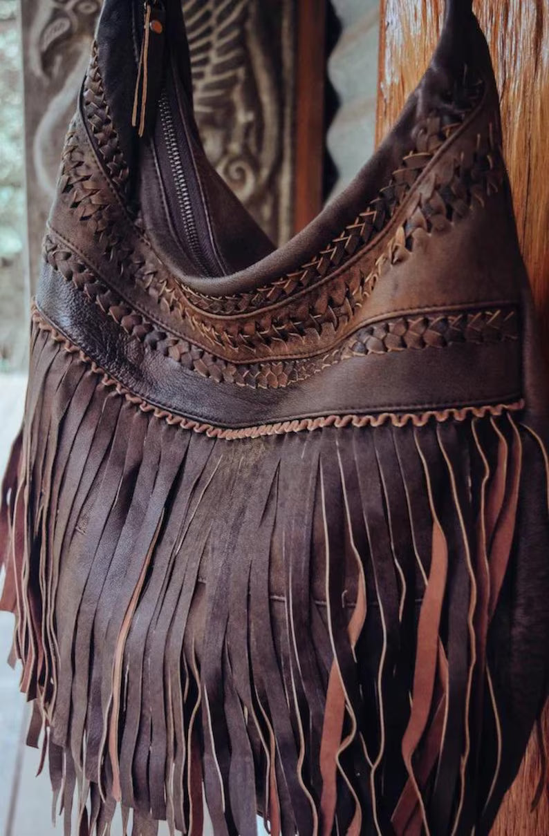 Handmade leather fringe shoulder bag in a vintage Western-Bohemian style.