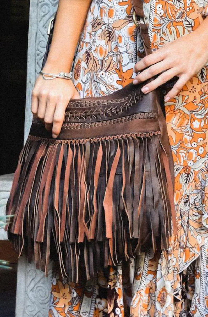 Handmade leather fringe shoulder bag in a vintage Western-Bohemian style.