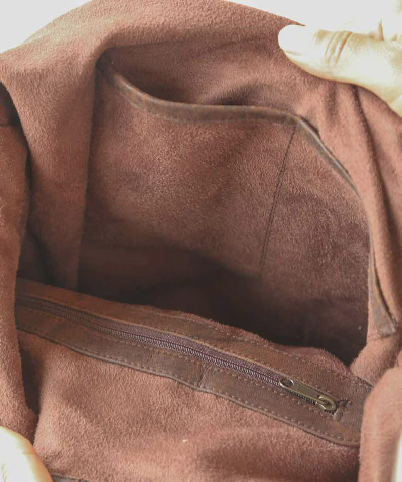 Handmade leather fringe shoulder bag in a vintage Western-Bohemian style.