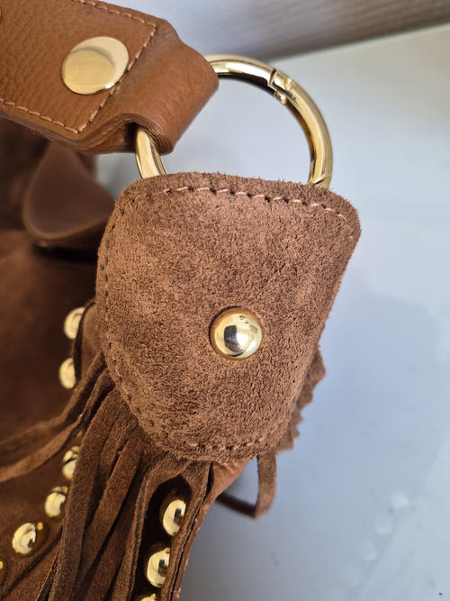Camel suede shoulder bag with tassels and gold studs.