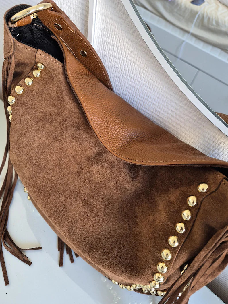 Camel suede shoulder bag with tassels and gold studs.