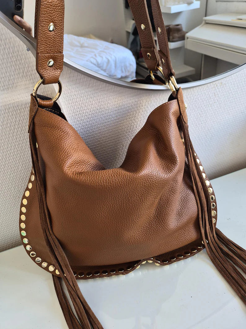 Camel suede shoulder bag with tassels and gold studs.