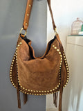 Camel suede shoulder bag with tassels and gold studs.